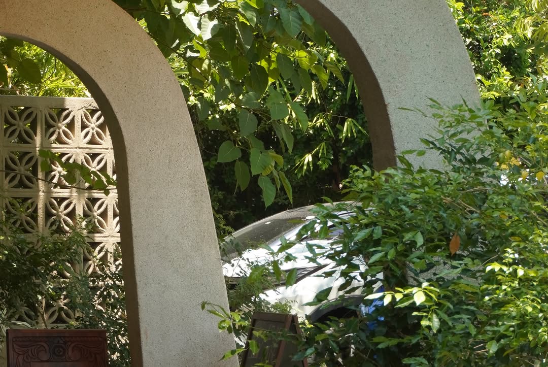 Arched concrete columns framing the garden entrance