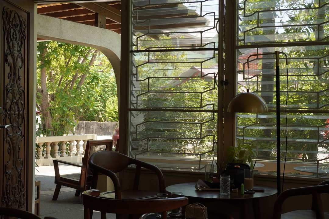 Cafe dining area with warm morning light through louvres