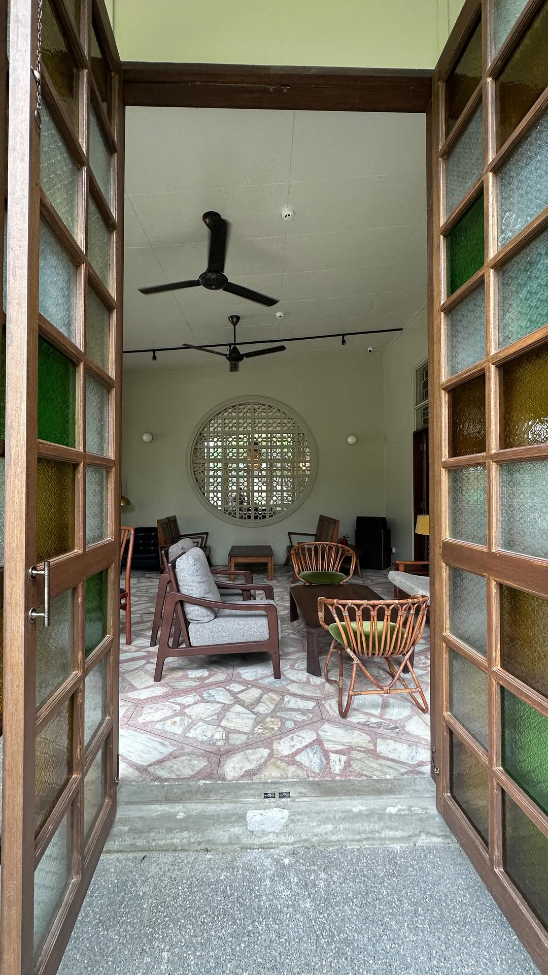 Entry hall view with stained glass panels and circular breeze block window